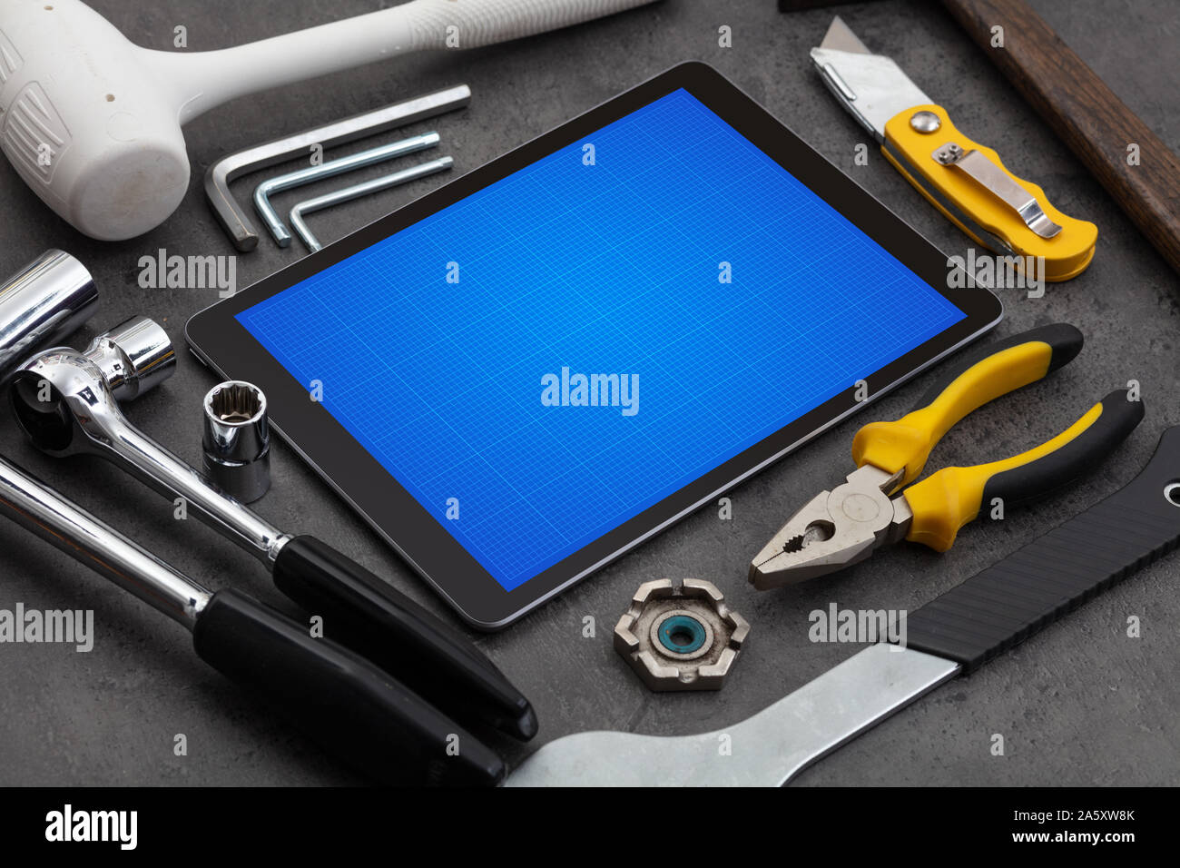 Household tools and tablet with grid screen concept Stock Photo - Alamy