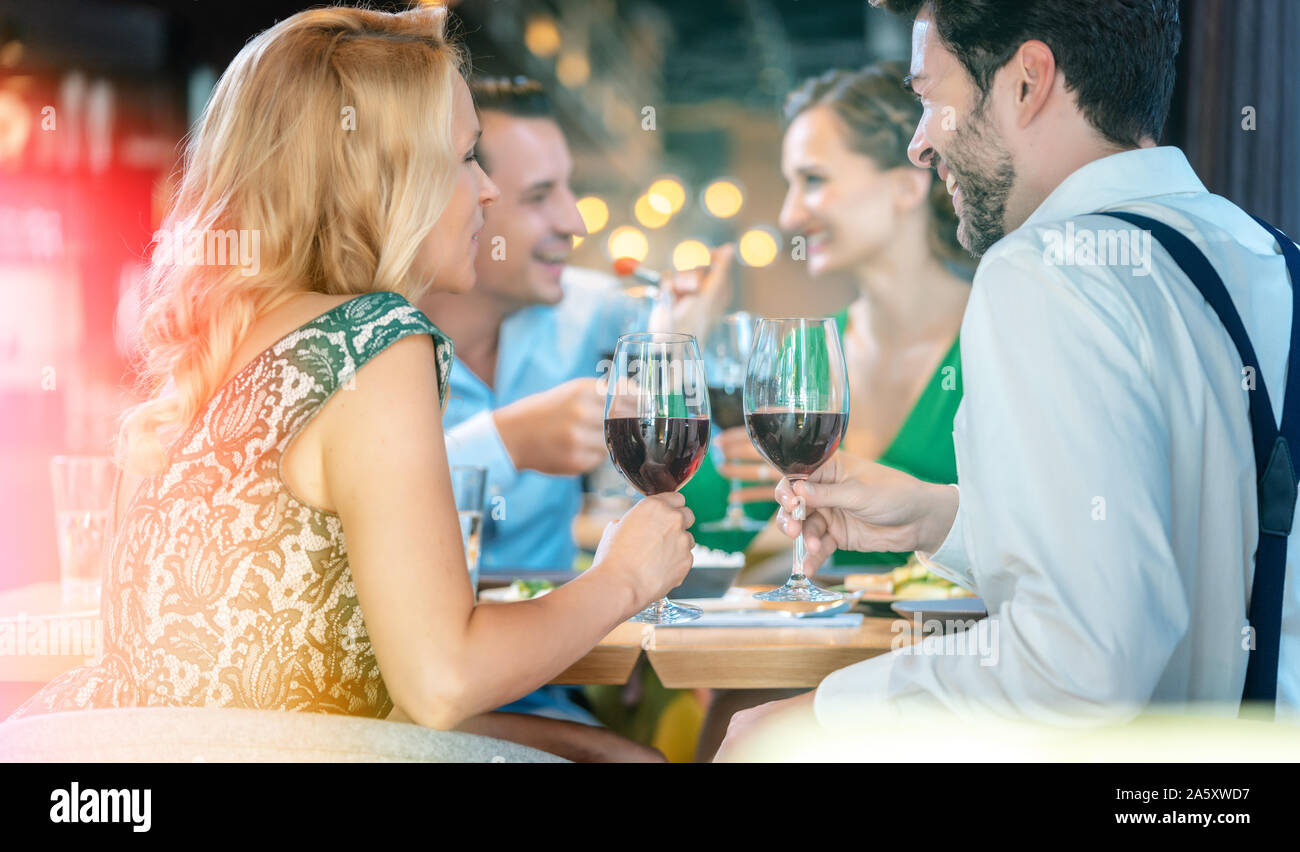 People in a restaurant eating and drinking red wine Stock Photo - Alamy