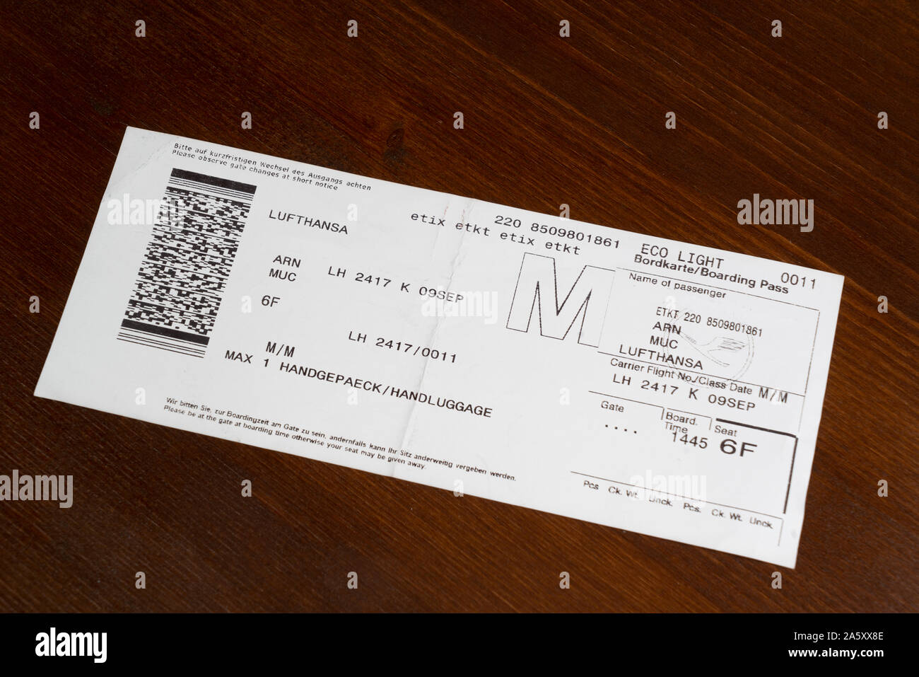 the boarding of the Lufthansa airline on a wooden table Photo