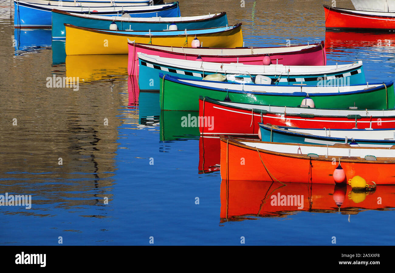 Alignment of small boats in bright colors. Stock Photo
