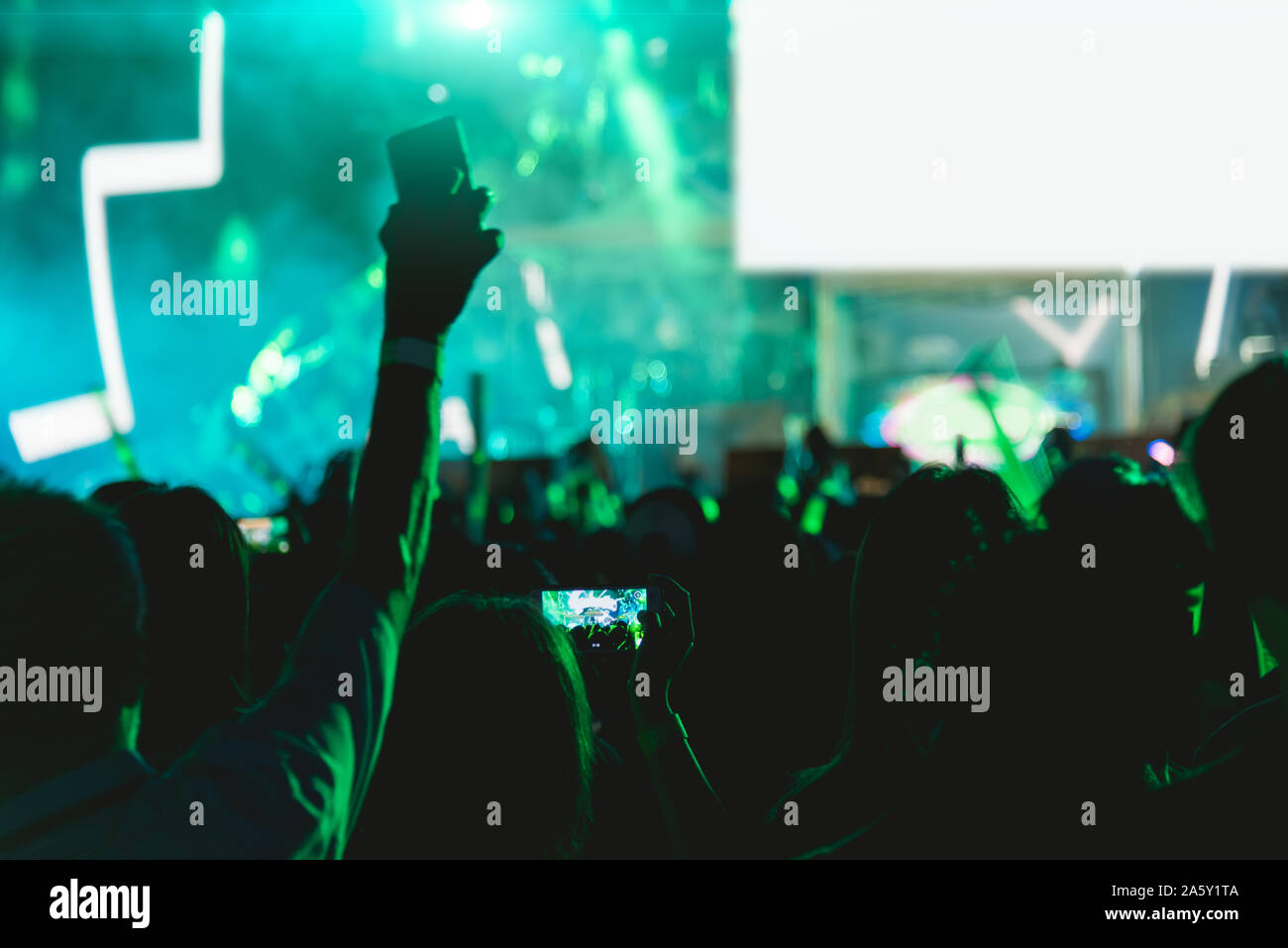 Concert crowd music festival, using mobile smart phone on stage lights ...