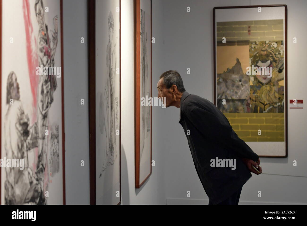Taiyuan, China's Shanxi Province. 23rd Oct, 2019. A visitor views the exhibits at an exhibition displaying newly-created Chinese painting art works portraying traditional opera characters in Taiyuan Art Museum in Taiyuan City, north China's Shanxi Province, Oct. 23, 2019. The exhibition displays more than 100 pieces of art works from more than 40 artists. Credit: Cao Yang/Xinhua/Alamy Live News Stock Photo