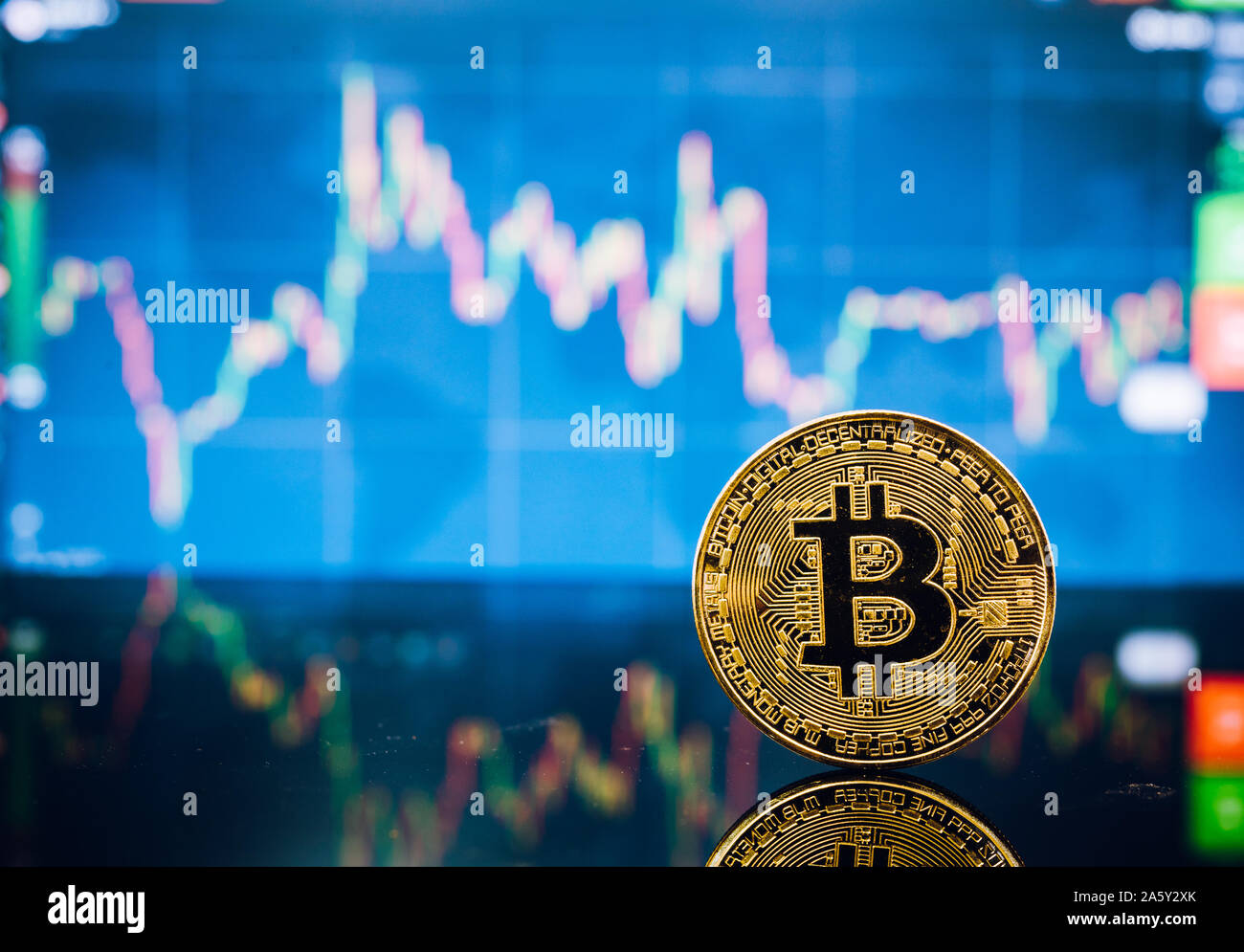 Bitcoin, virtual golden bit coin money on candle stick graph chart  background Stock Photo - Alamy