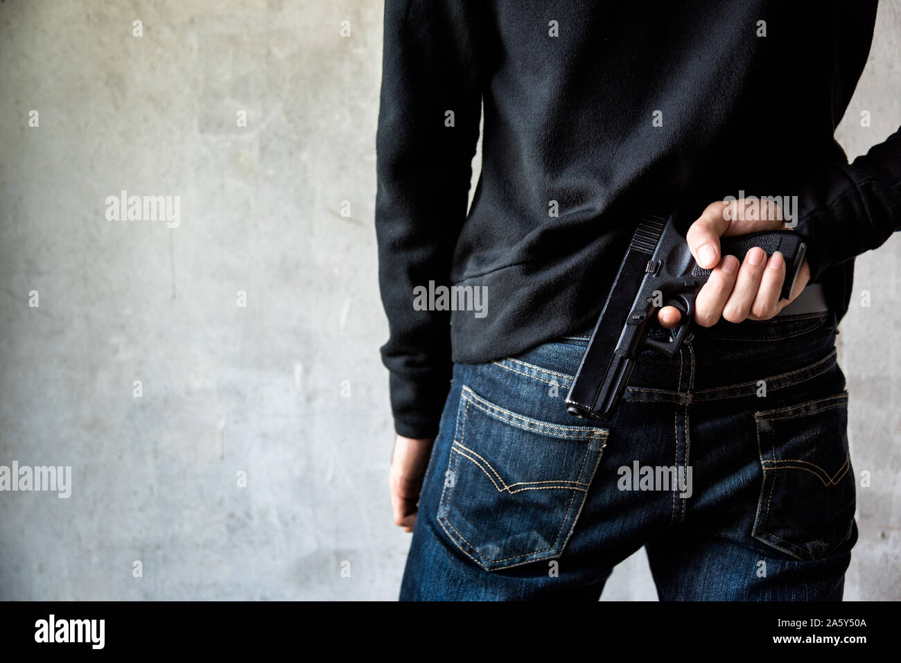 Gun hidden behind back hi-res stock photography and images - Alamy