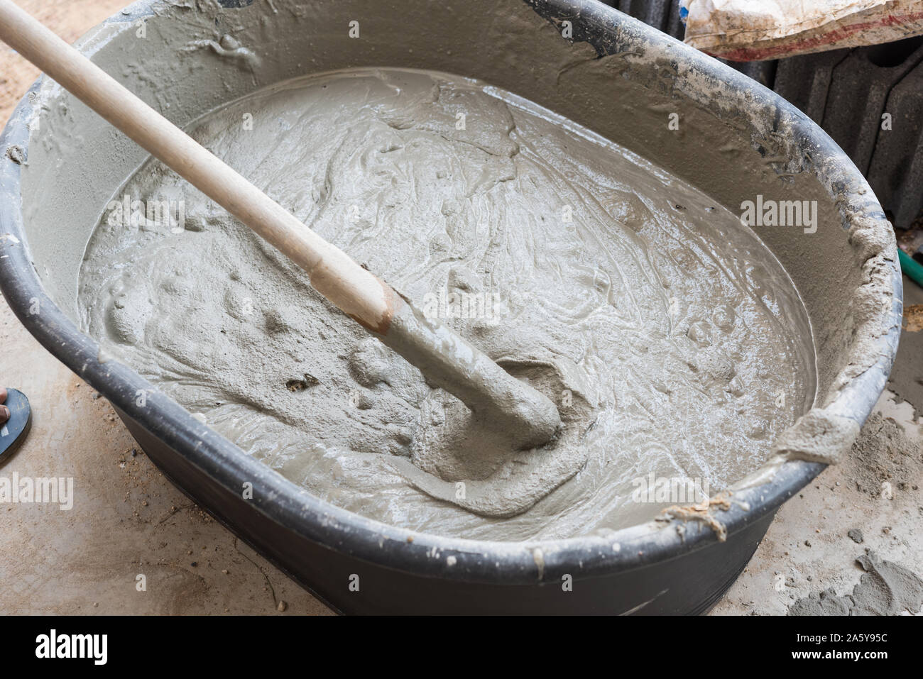 cement mix concrete is compacted sand by spade for construction Stock Photo  - Alamy
