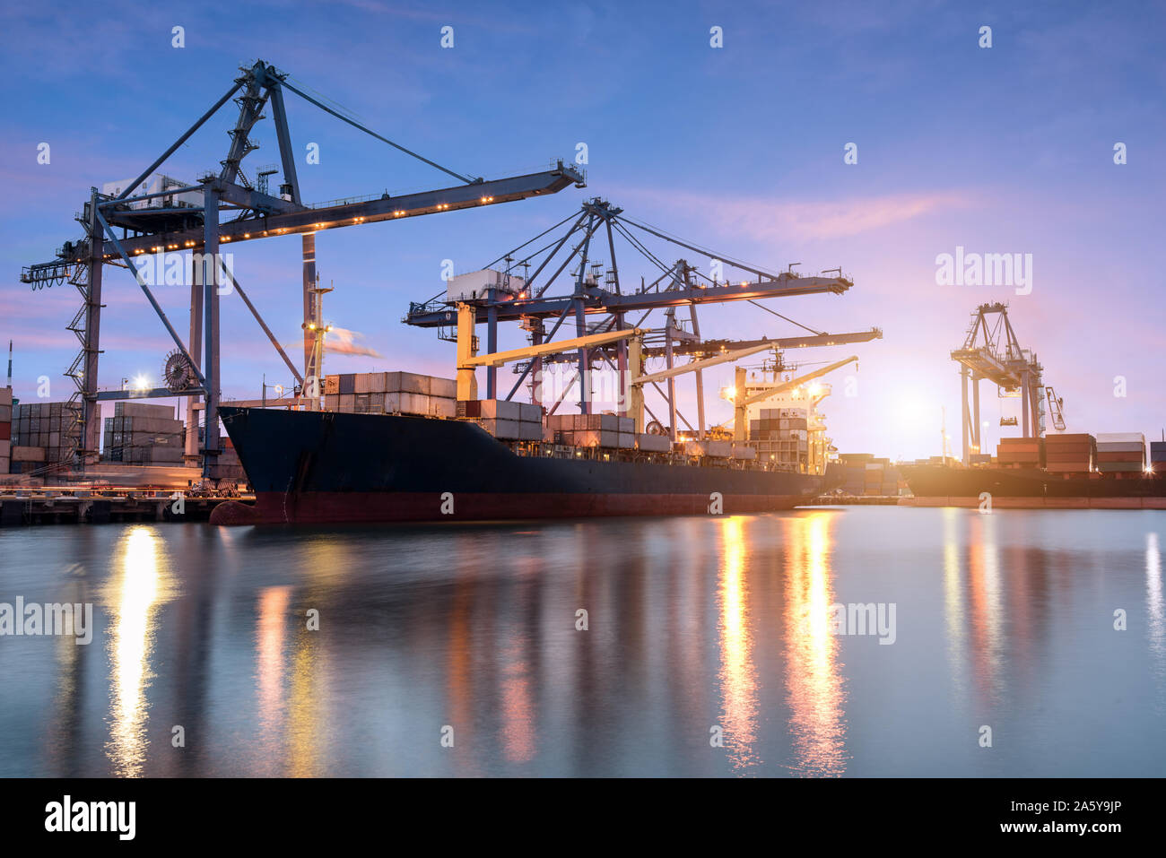 Container ship in the harbor at sunrise Stock Photo - Alamy