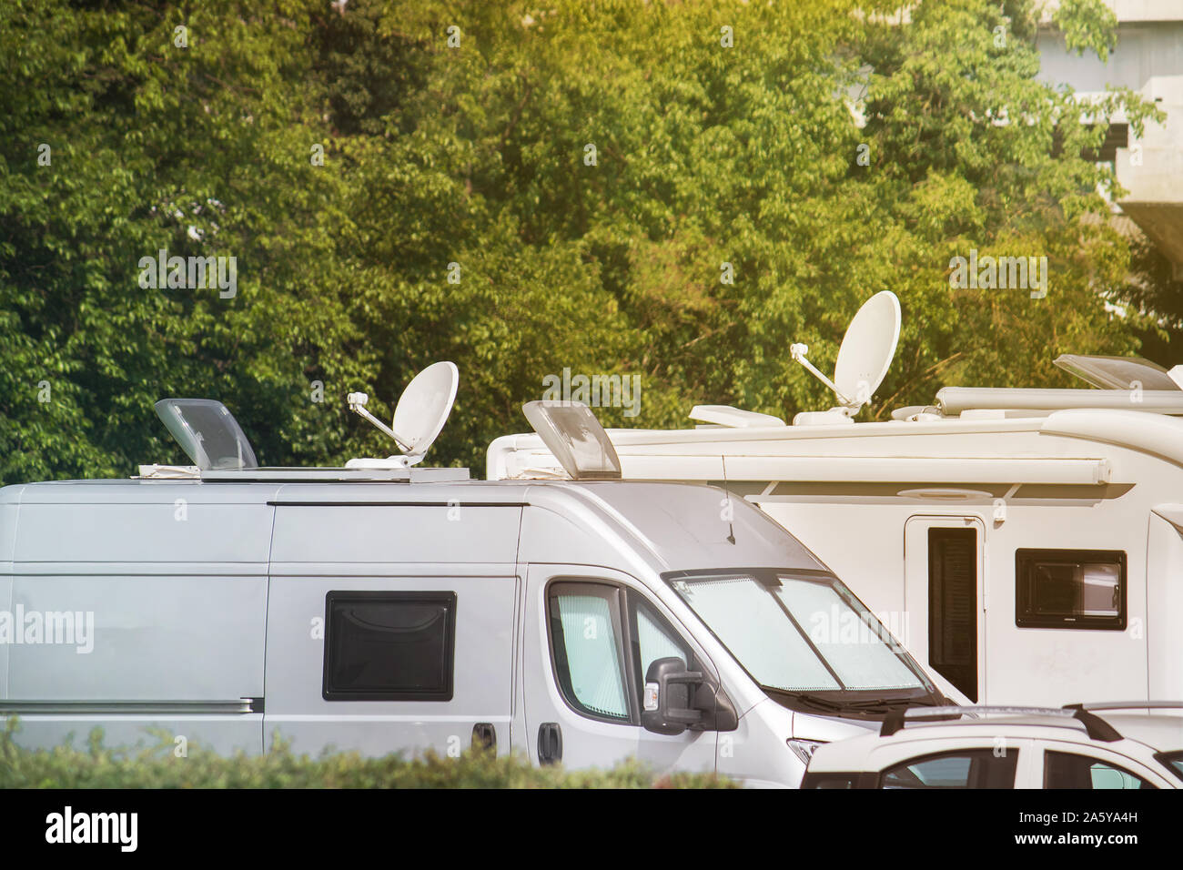 Satellite dishes on caravans. Electronic equipment on vans and campers for receiving video signals (copy space on the top of the image) Stock Photo