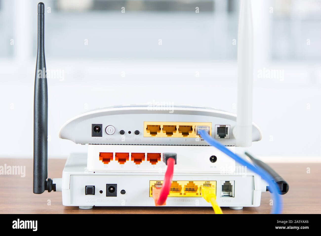 Wireless modem router network hub with cable connect on wooden table in the  room Stock Photo - Alamy