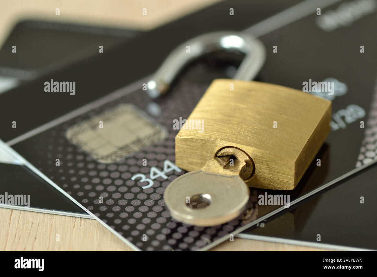Unlocked padlock with key on credit card Concept of security and