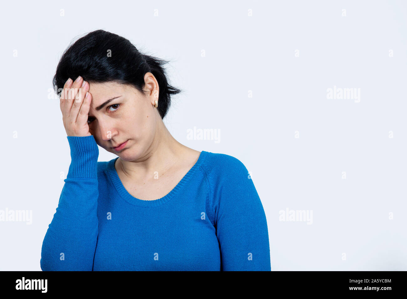 Desperate young woman holding hands in hair throwing a tantrum, having