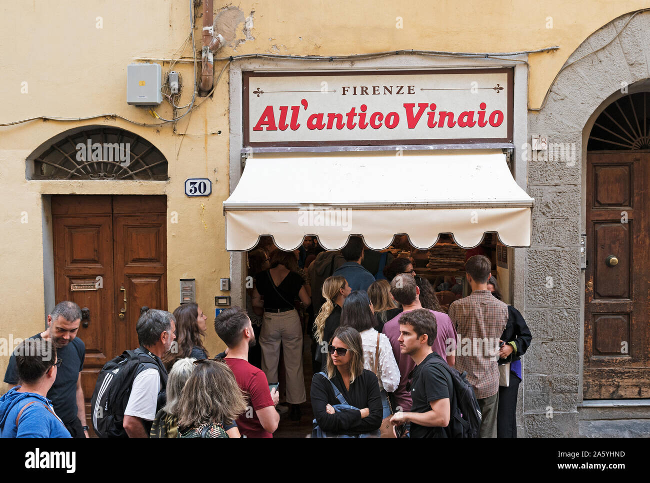 visitors tourists customers queue outside the famous All antico Vinaio for tuscan cuisine fast food takeaway. Stock Photo
