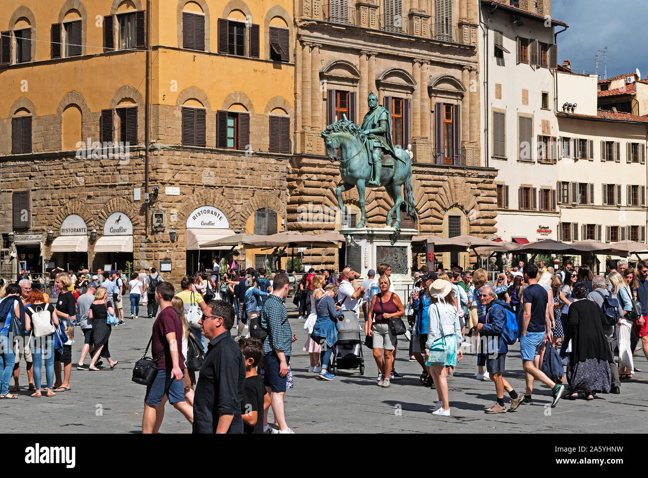 tourists visitors on piazza della signoria in the tuscan city of florence, italy. Stock Photo