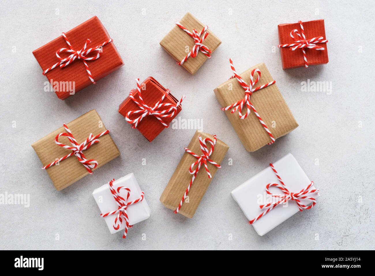 Various gift boxes decorated with colorful twine on gray background. Flat lay. Sale concept. Stock Photo