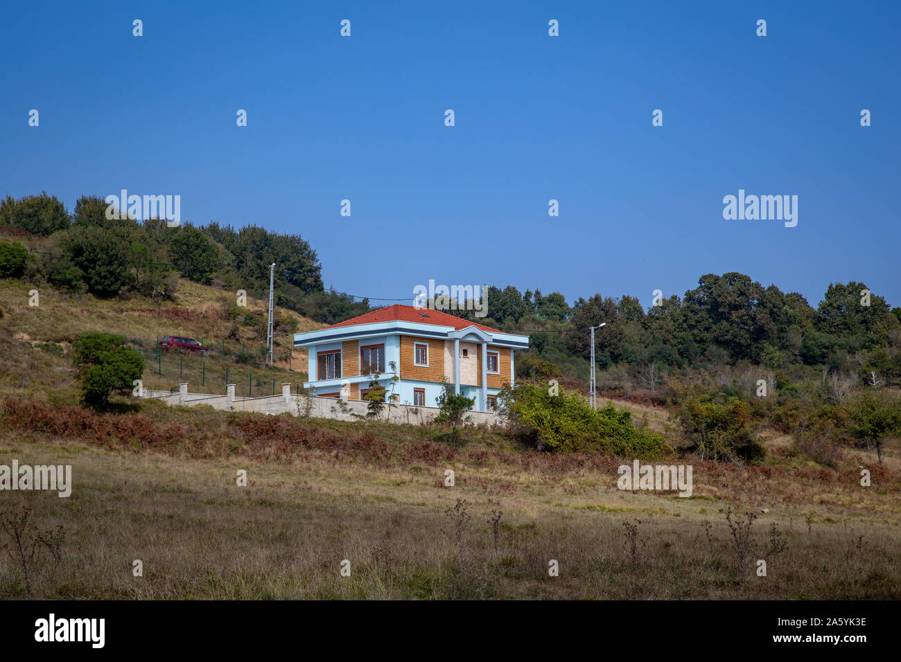 Turquoise colored two storey house in the distance view Stock Photo