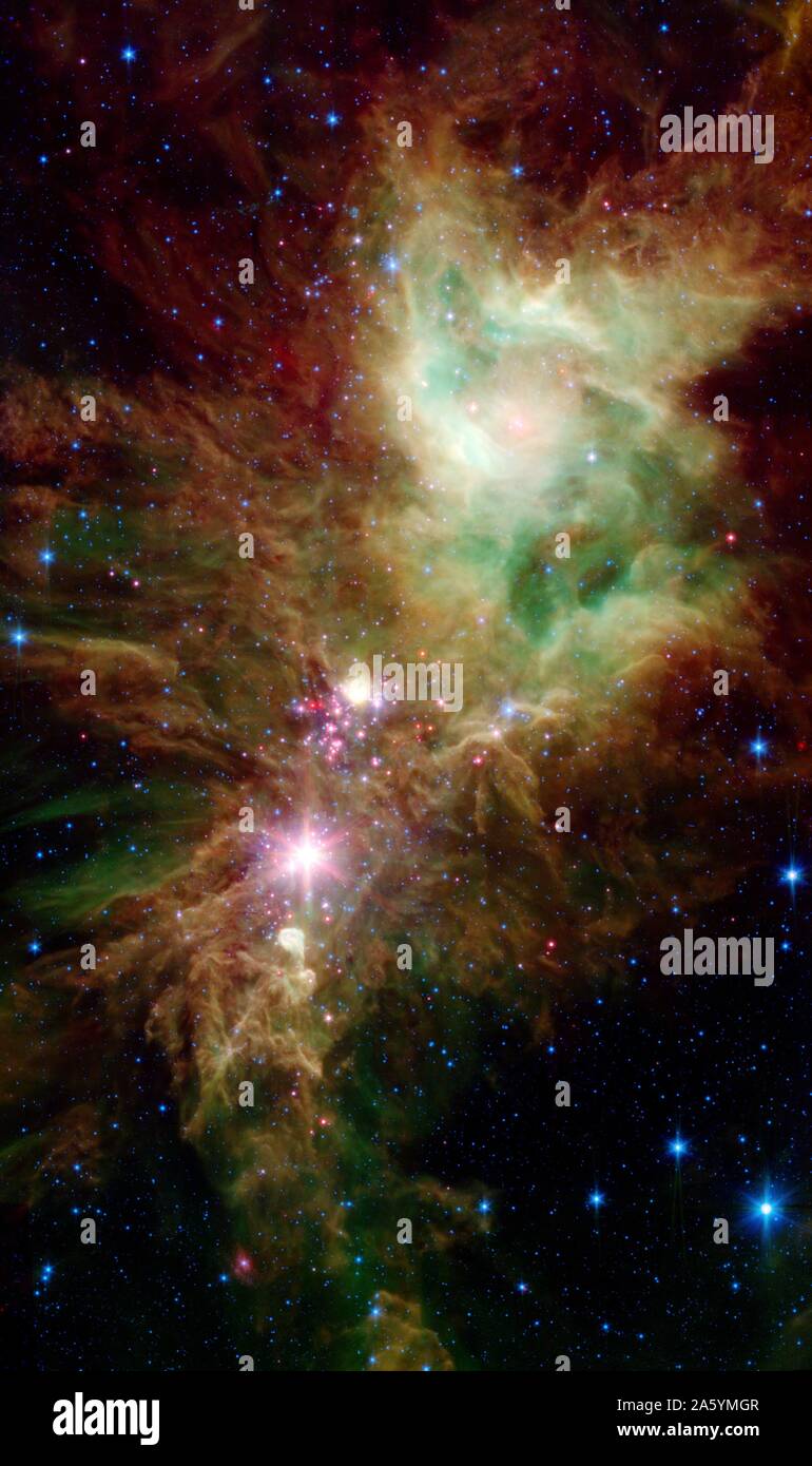 Newborn stars, hidden behind thick dust, are revealed in this image of a section of the Christmas Tree cluster. Stock Photo
