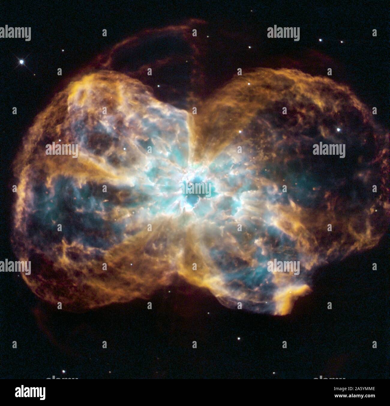 The star is ending its life by casting off its outer layers of gas, which formed a cocoon around the star's remaining core. Ultraviolet light from the dying star makes the material glow. The burned-out star, called a white dwarf, is the white dot in the center. Hubble Space Telescope (HST). Stock Photo