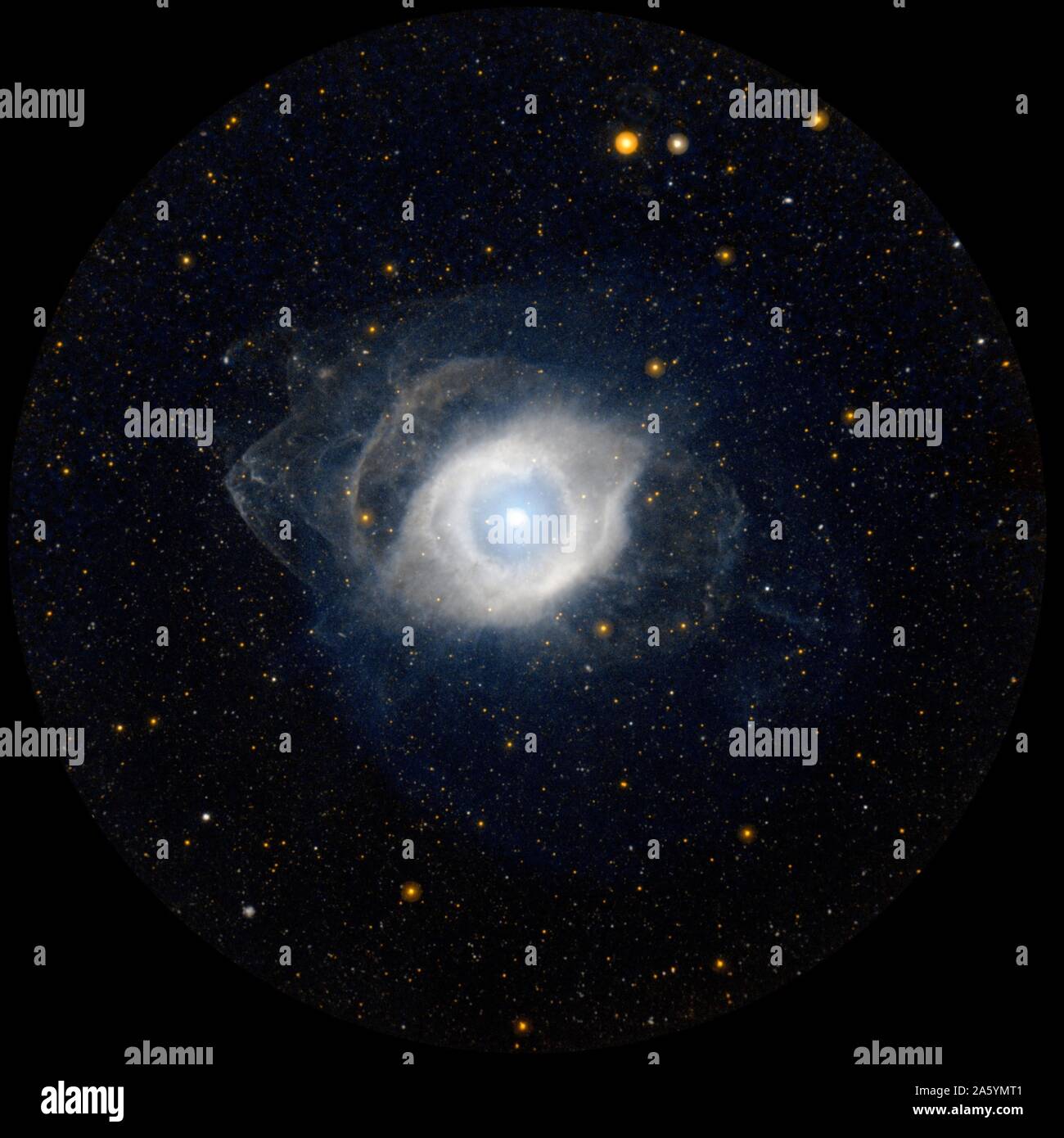 NGC 7293, better known as the Helix nebula. The Helix is the nearest example of a planetary nebula, which is the eventual fate of a star, like our own Sun, as it approaches the end of its life. GALEX. Stock Photo