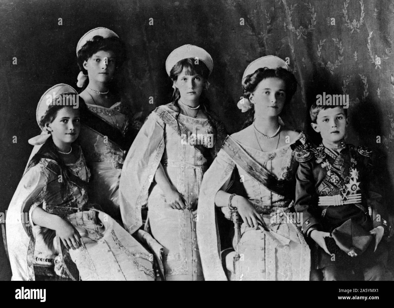 Photograph of the Romanov Children from the Russian Royal family taken in the early 1900's. Showing Olga, Tatiana, Maria, Anastasia and Aleksei posing together for an official portrait. Stock Photo