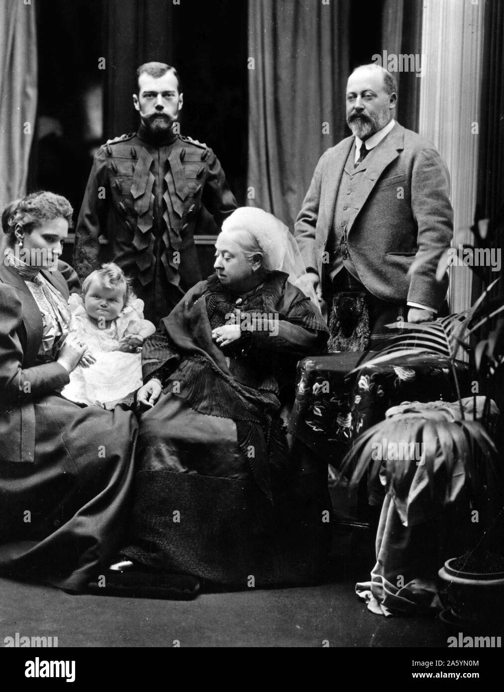 A photograph of Tsar Nicholas II, (the last Emperor of Russia, Grand Duke of Finland, and King of Poland) Empress Alexandra Fedorovna, Grand Duchess Olga, Queen Victoria, and Edward, Prince of Wales taken in Balmoral castle in 1896. Stock Photo