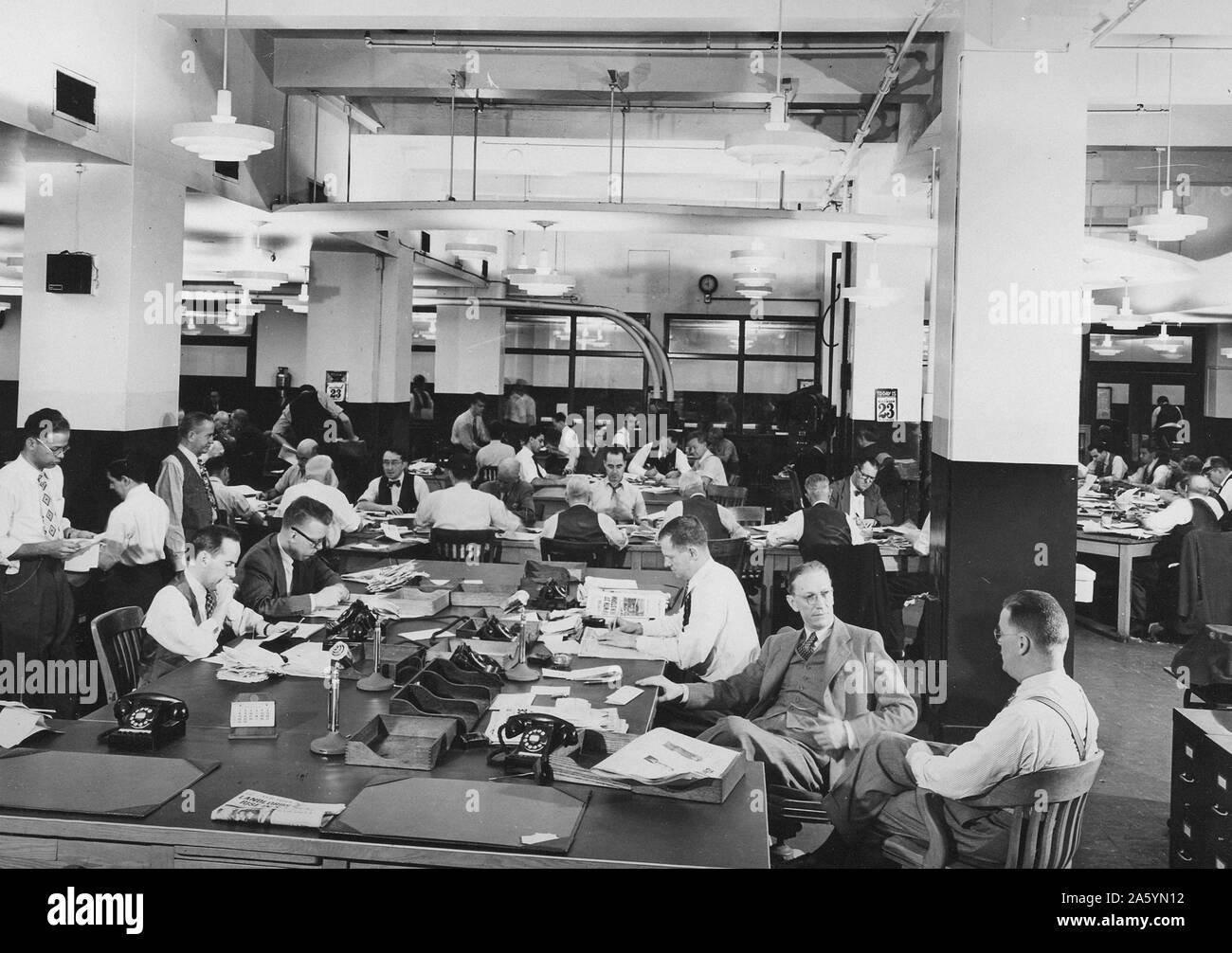 journalists sitting in a news room at an American newspaper office circa 1945 Stock Photo