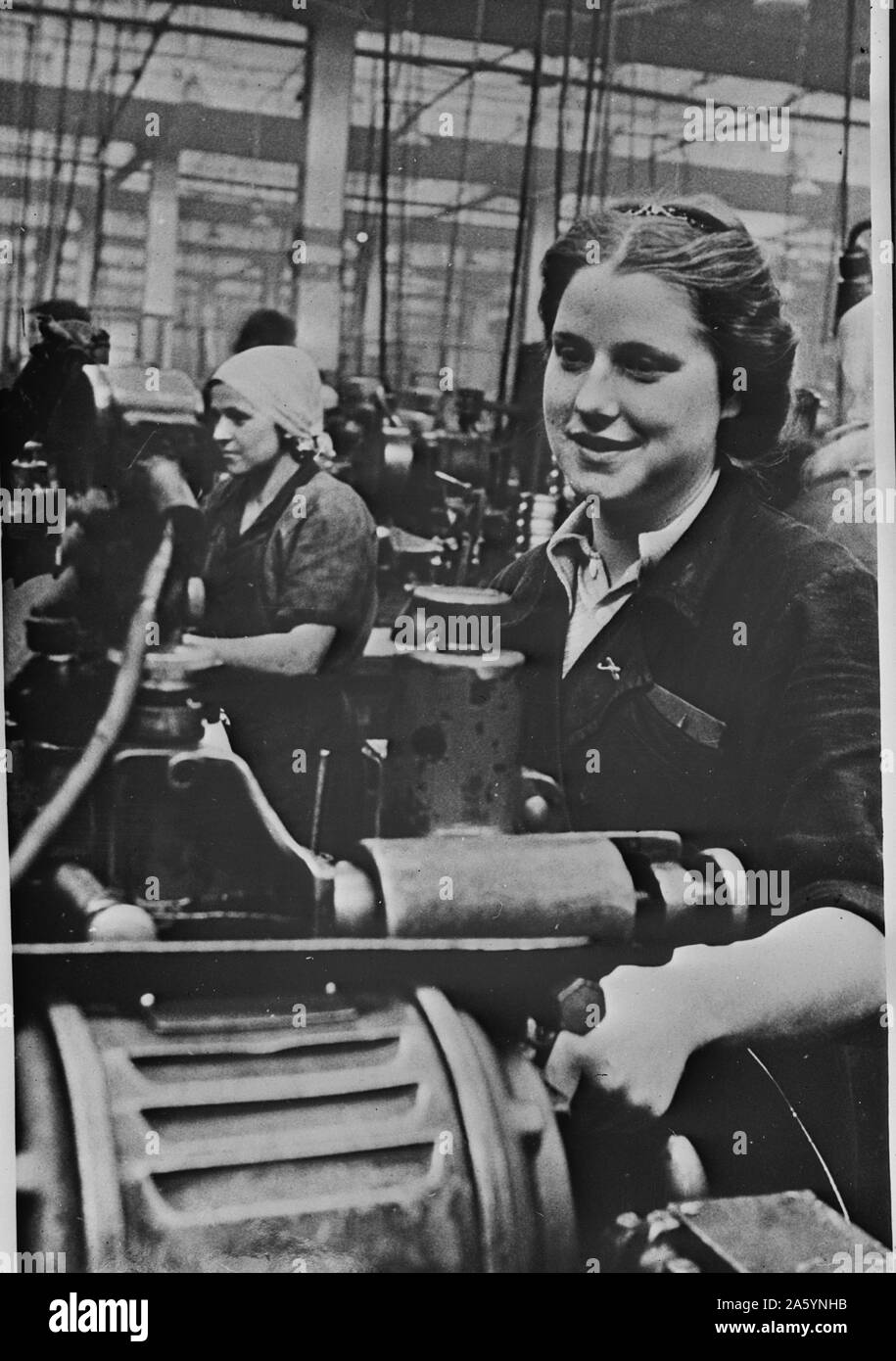 Women handling lathe in a factory in the USSR (Union of Soviet Socialist Republics) 1940 Stock Photo