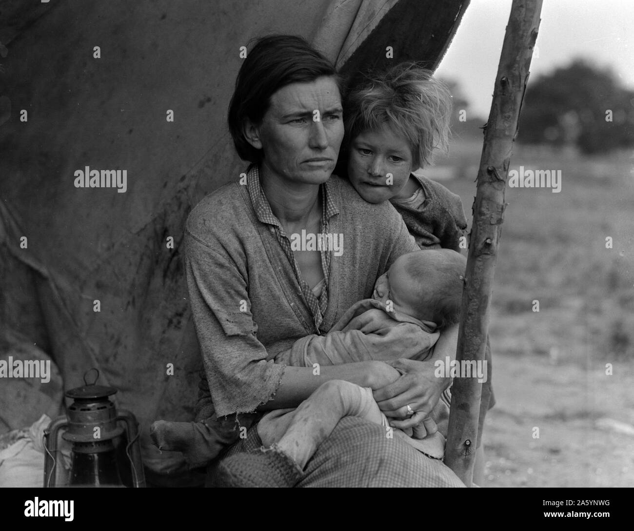 Migrant agricultural worker's family. Seven hungry children. Mother aged thirty-two. Father is native Californian. Nipomo, California by Dorothea Lange 1895-1965, dated 1936 . Photo shows Florence Thompson with several of her children in a tent shelter as part of the 'Migrant Mother' series 1936 Stock Photo