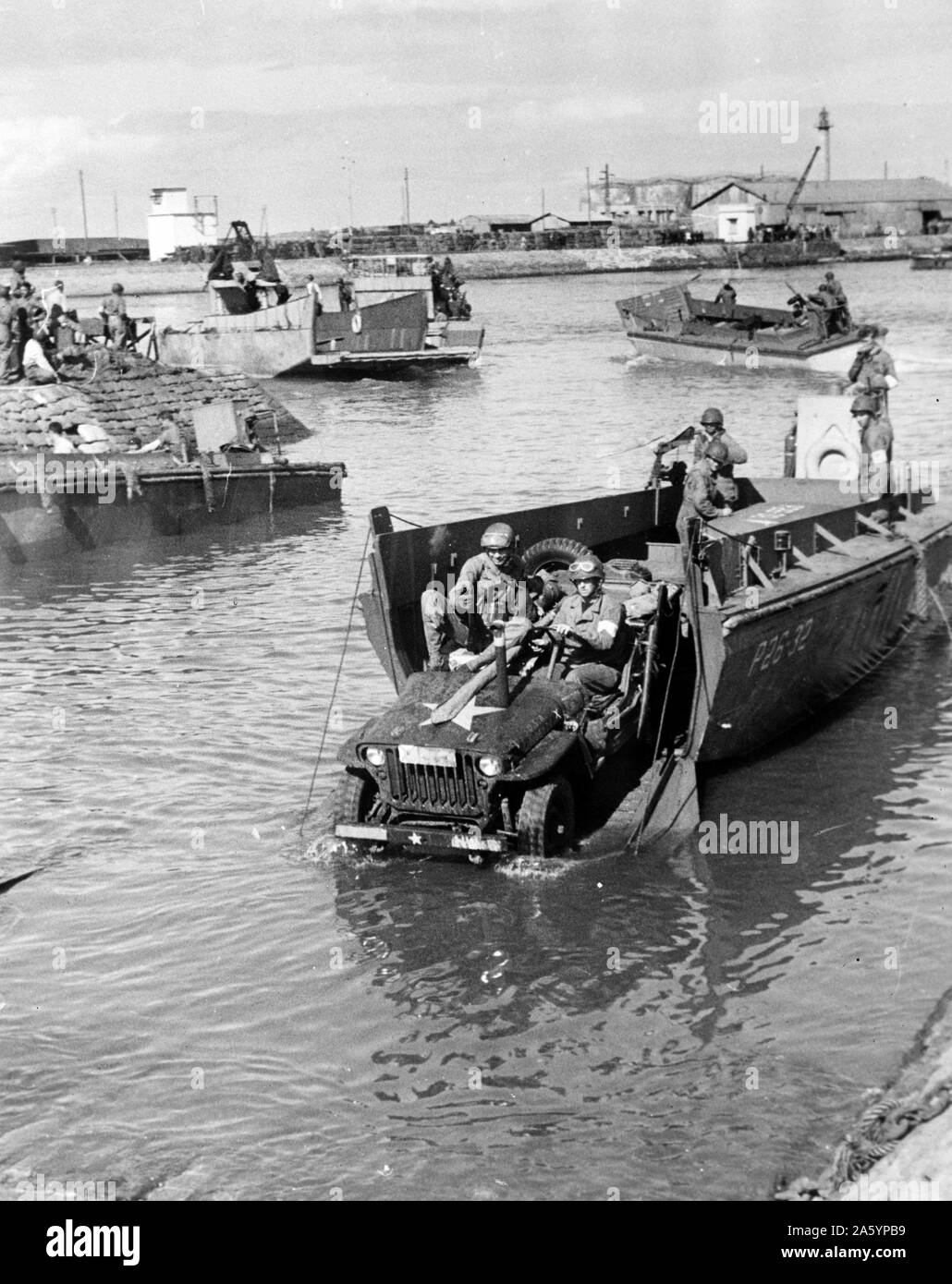 Photograph of a Jeep being rolled off a landing boat at Fedala harbour during the landing operations of the U.S. task forces. Dated 1942 Stock Photo
