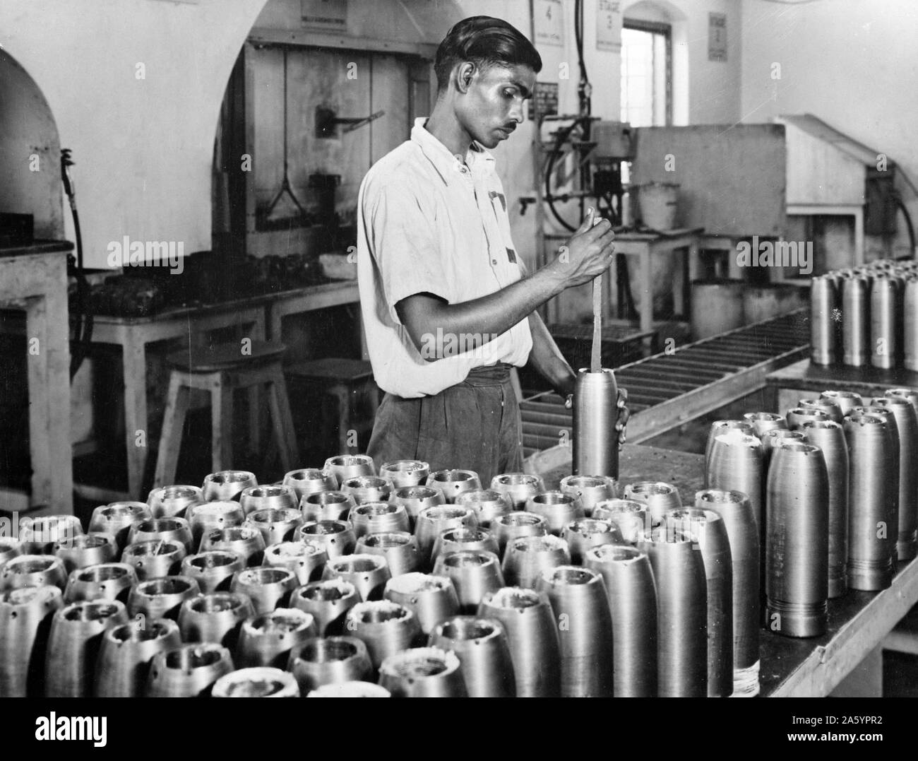 India in the war. A worker in one of India's fast expanding munitions plants. India produces more than 50 different kinds of arms and ammunition of the most up-to-date type. Altogether 75% of her requirements of war supplies are made India. Stock Photo