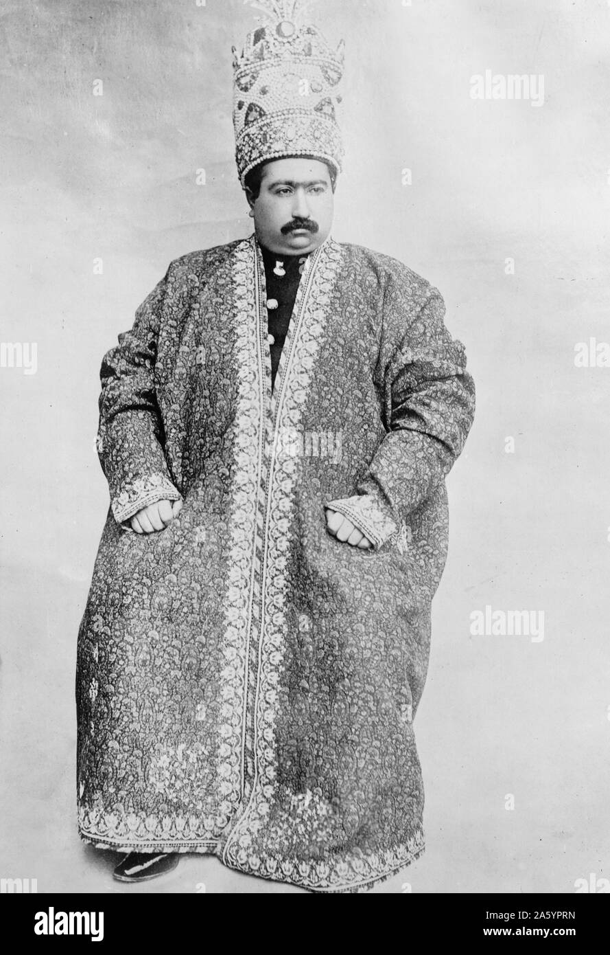 Shah of Persia, Mohammed Ali Mirzi, December 19, 1907. Photograph shows the Shah of Persia, full-length portrait, seated, wearing an ornate robe and crown. Stock Photo