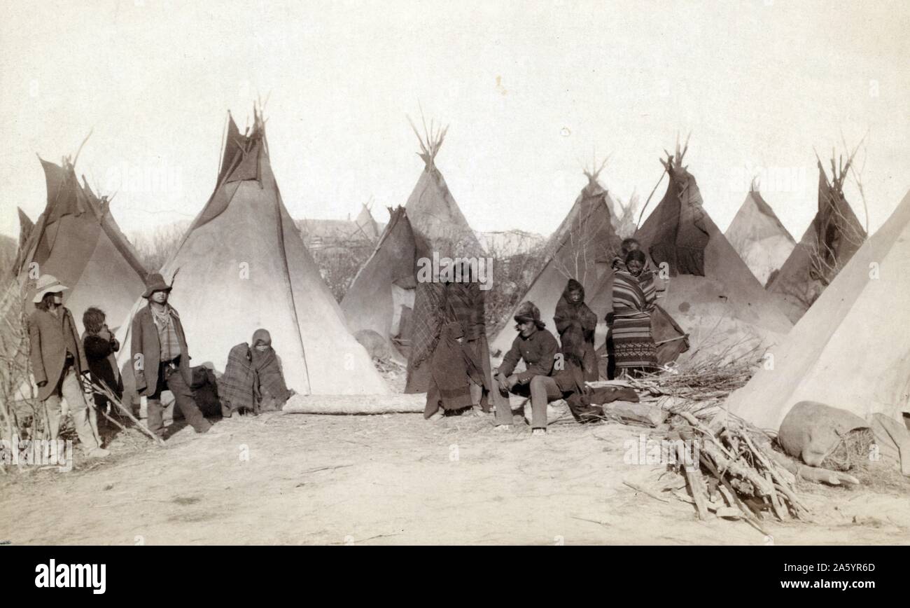 Photographic print of a group of Miniconjou peoples in a tepee camp, near Pine Ridge Reservation. Photographed by John C. H. Grabill. Dated 1891 Stock Photo