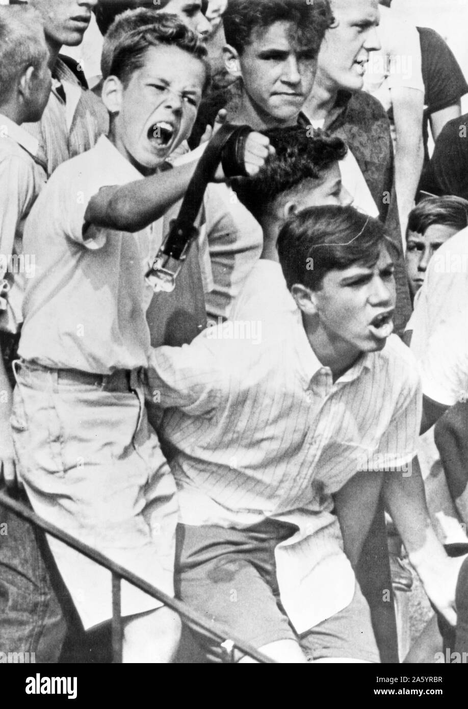 Young boys harassing the Baker family, the first African American