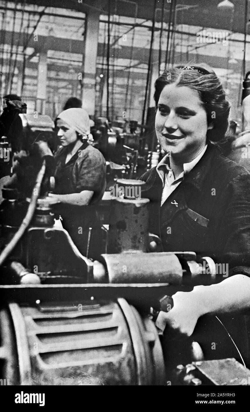 Women handling lathe in a factory in the USSR during world war two. Stock Photo