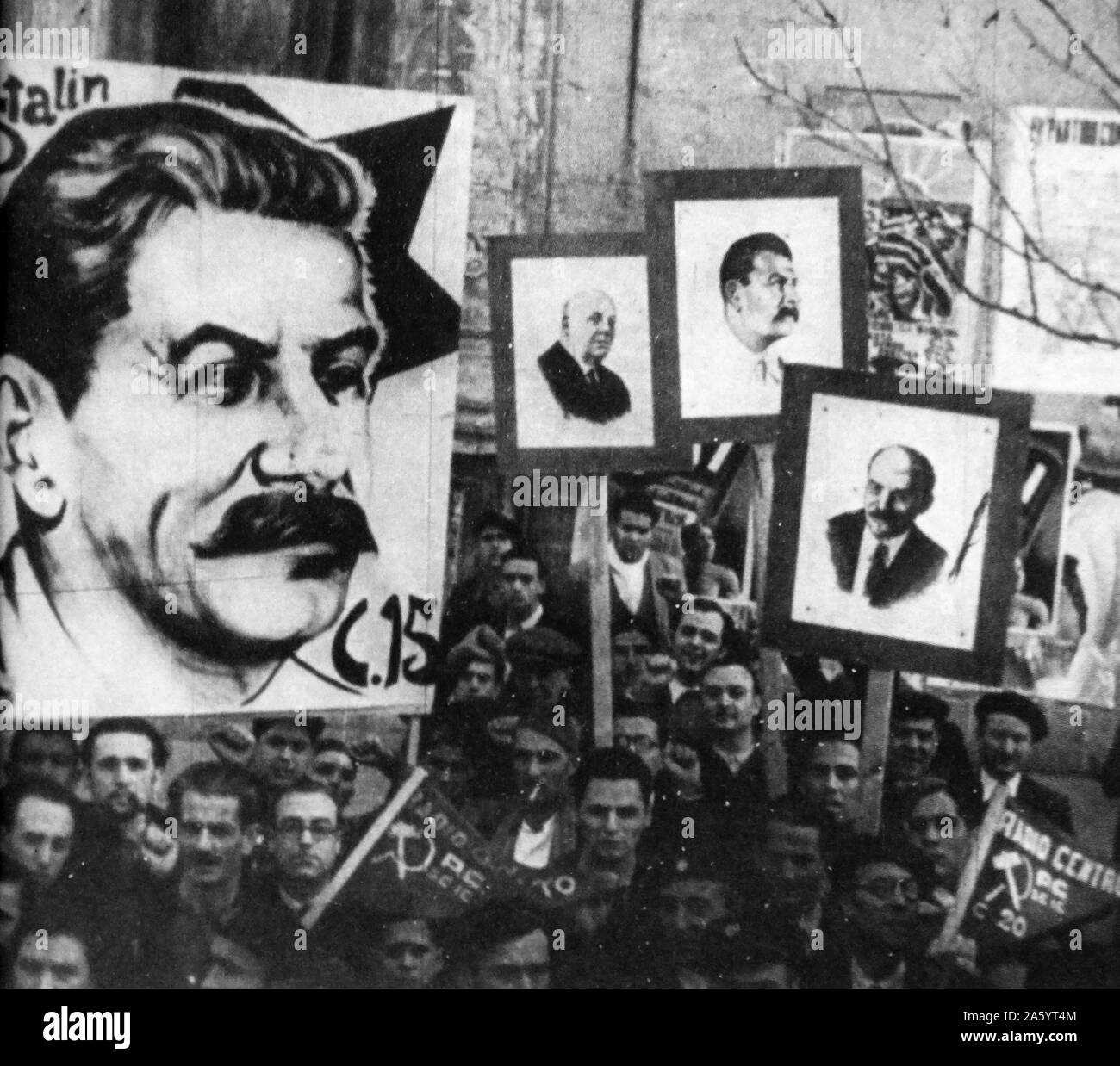During the Spanish Civil War, Communist demonstrators in Spain carry placards with images of Stalin and Lenin. Stock Photo