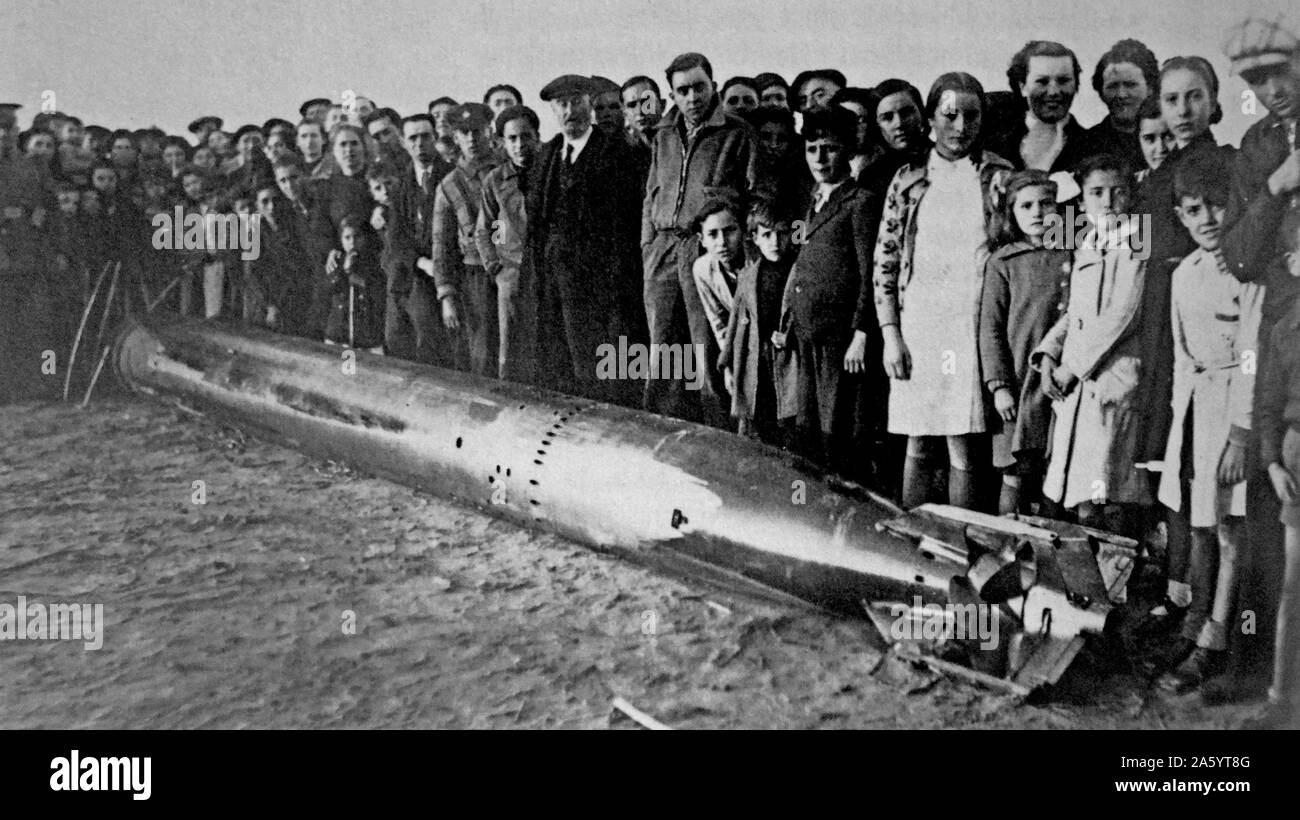 Unexploded rocket shell examined by civilians during the Battle for Tarragona, Spain 1939 during