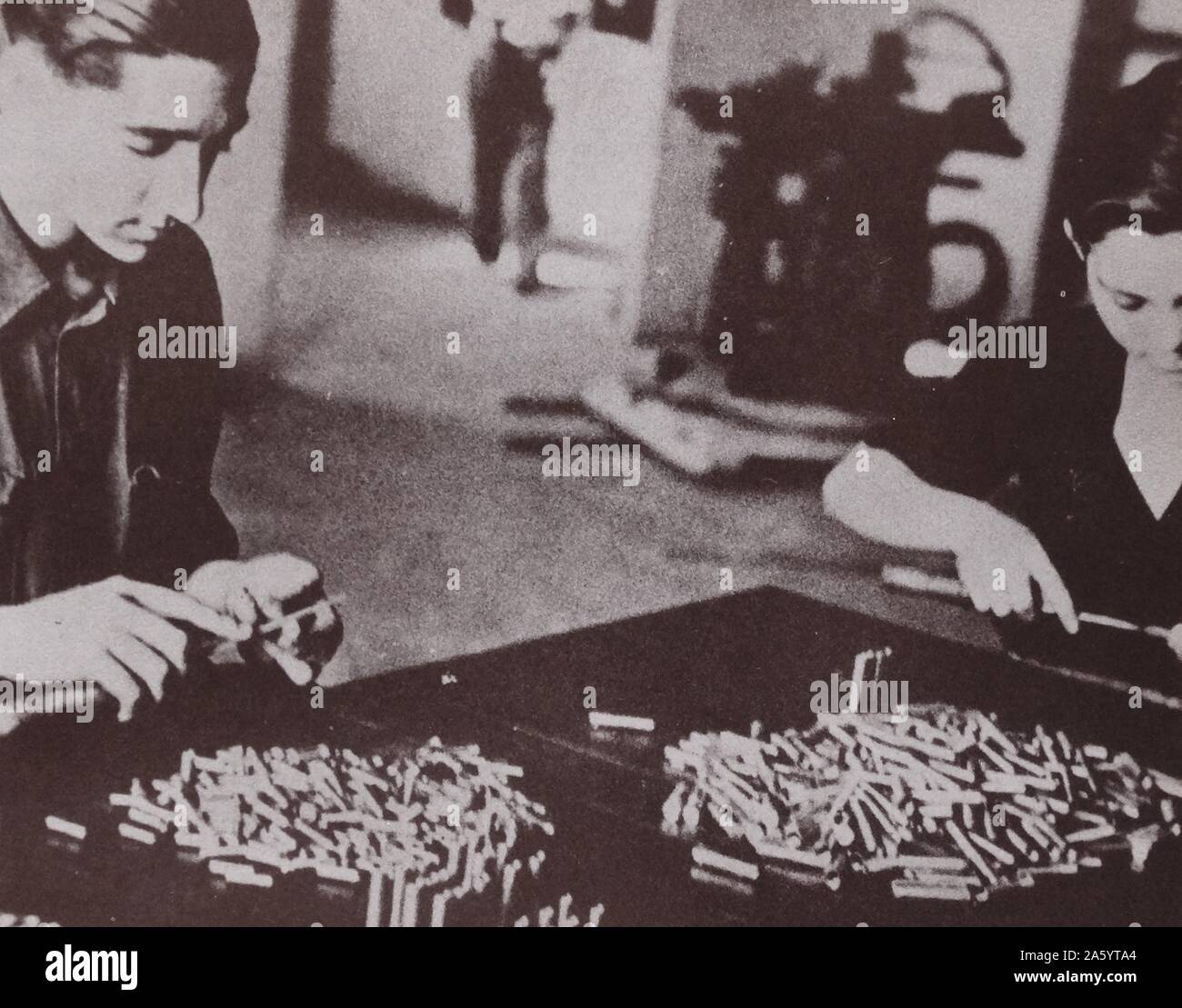 man and woman working in a republican munitions factory during the Spanish Civil War Stock Photo