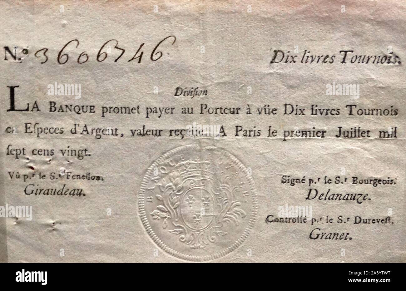 10 livres tournois banknote, issued by the Banque Royale, France, 1720. In 1716, Scottish economist John Law established a bank in France. It was bought by the French government in 1718 and renamed the Banque Royale. Law also founded the Mississippi Company. However, he overvalued its assets, creating a bubble, as more and more people bought shares. shareholders demanded cash payment, leading to a run on the bank and financial chaos in France. Stock Photo