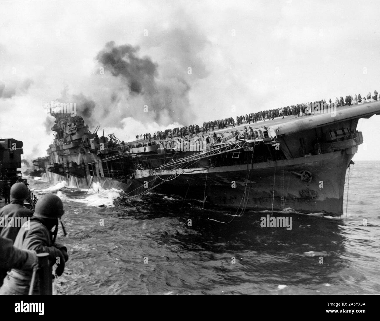 Aircraft carrier USS Franklin (CV-13) attacked by Japanese navy, during World War II, March 19, 1945. Stock Photo