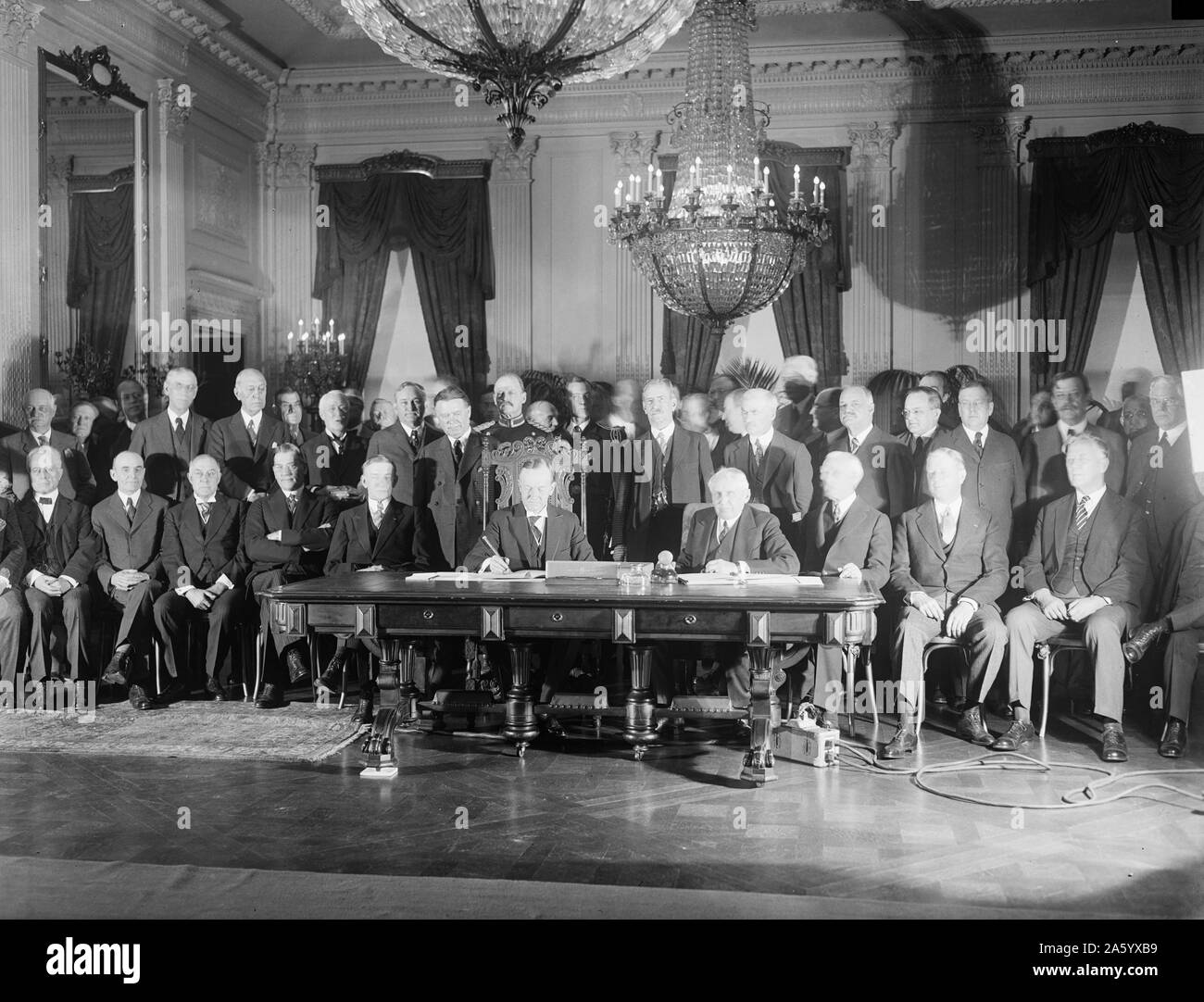 Photograph of President Calvin Coolidge (1872-1933) signing the Kellogg Treaty. Dated 1928 Stock Photo