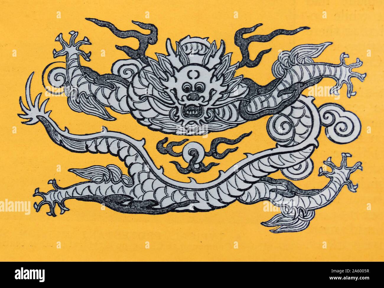 Chinese dragon emblem on a yellow background; from a 1900 illustration Stock Photo