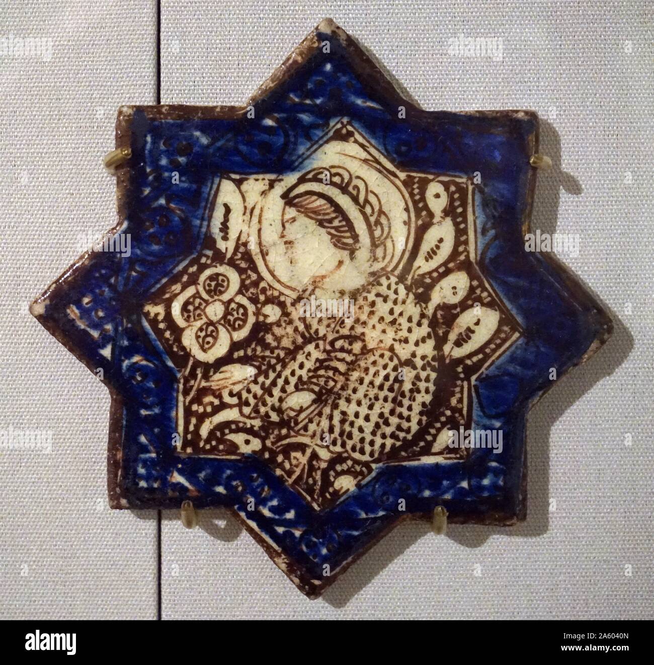 Lustre star tiles with blue borders, from Iran, Kashan. Dated 13th Century Stock Photo