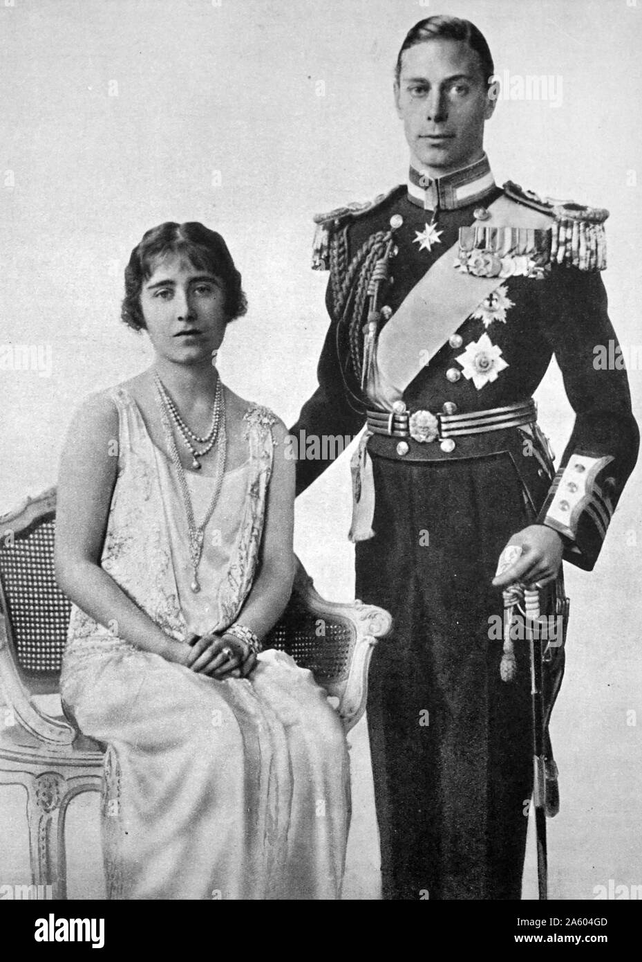 Photograph of the recently engaged Prince Albert Frederick Arthur George (1895-1952) and Lady Elizabeth Bowes-Lyon (1900-2002) in full dress for the King and Queen of Rumania's visit to the England. Dated 20th Century Stock Photo