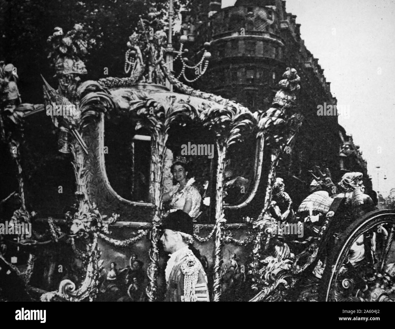 Photograph of the Queen Elizabeth II (1926-) within the Glass Coach, renovated for the Queen's crowning Stock Photo