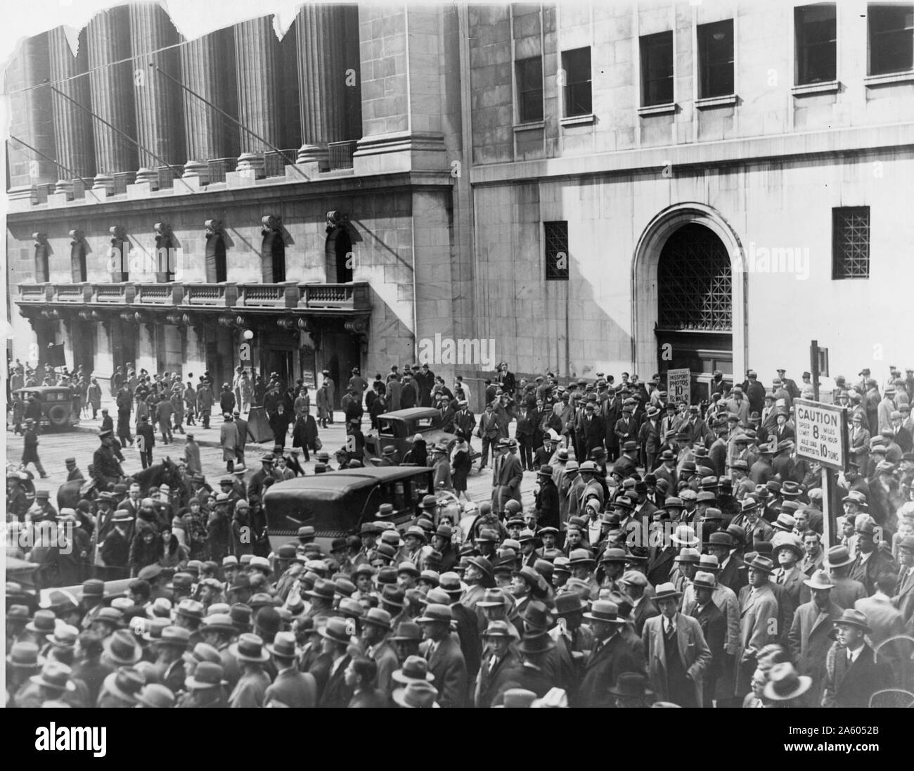 A crowd of people gather outside the New York Stock Exchange following the Crash of 1929. Also known as Black Tuesday it was the most devastating stock market crash in the history of the United States and signalled the beginning of the 10-year Great Depression that affected all of the Western industrialized countries. Stock Photo
