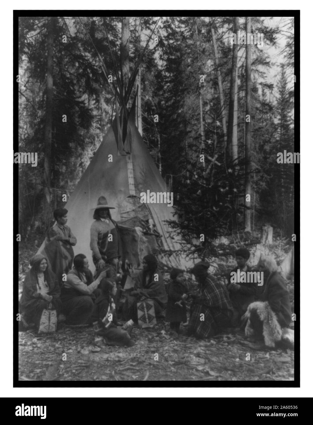 Flathead Indians holding pre-Christmas family gatherings on the west side of Glacier National Park, in the dense forest of evergreen trees that skirt the Rocky Mountains. Stock Photo