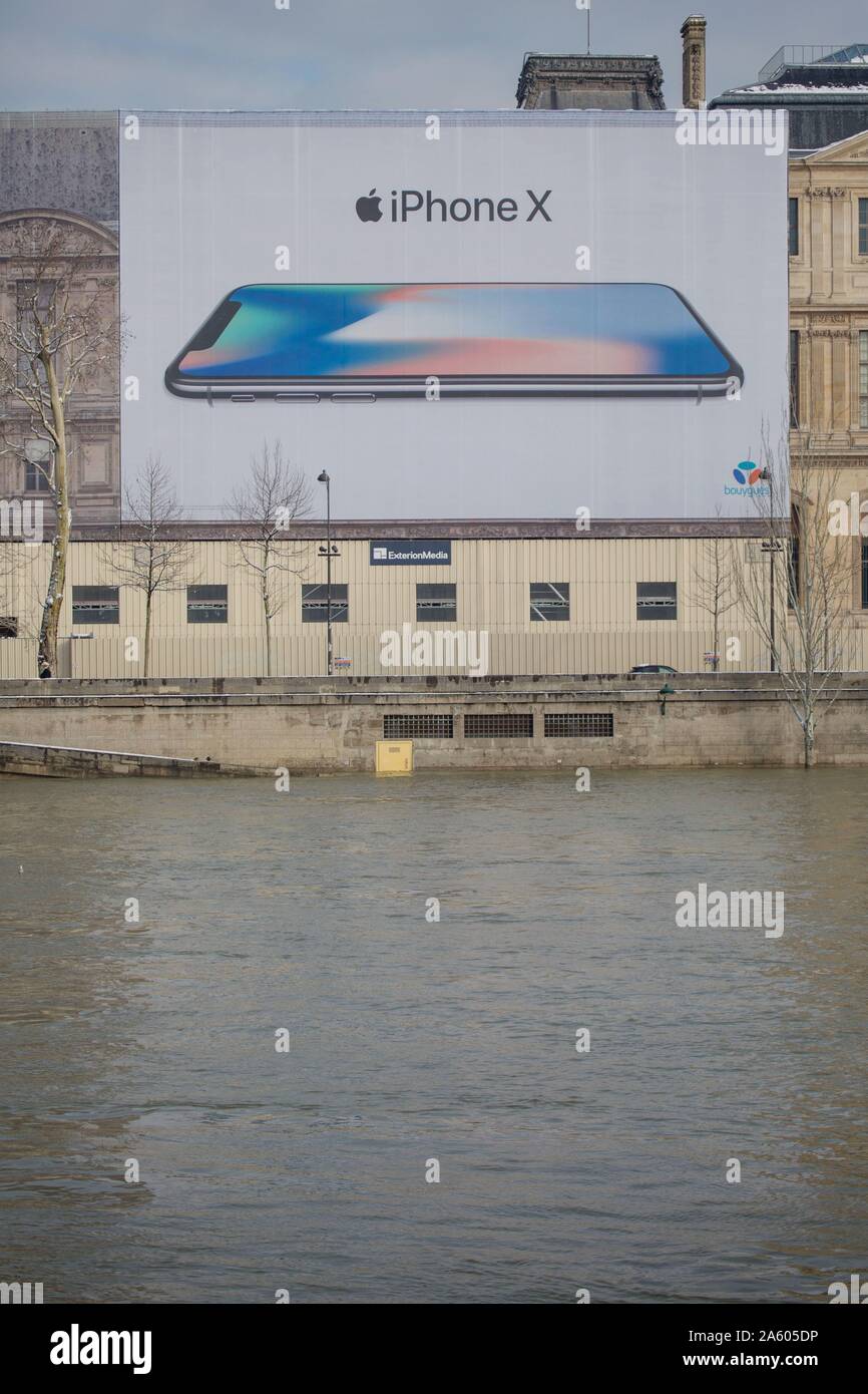 France, Paris 7th arrondissement, Quai Voltaire, second hand book seller box, advertising tarp Apple, Iphone, work on the facade of the Louvre, Stock Photo