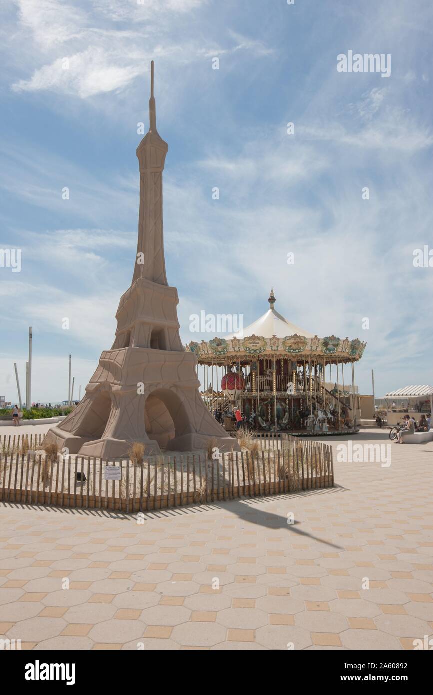 Côte d'Opale, Le Touquet Paris Plage, Place du Centenaire, sculpture of the  Eiffel Tower by French sculptor Alain Godon, merry go round Stock Photo -  Alamy
