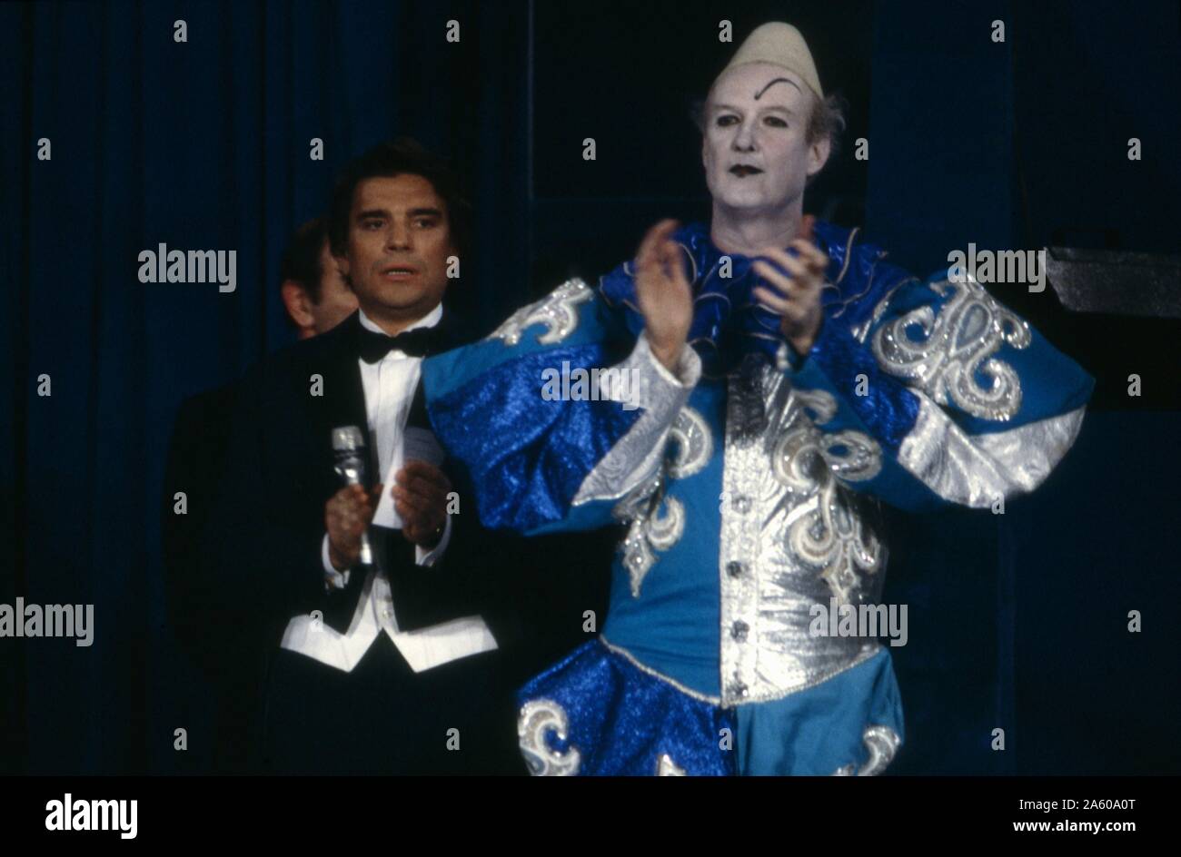 French businessman and politician Bernard Tapie presenting the Gala de la Presse at the Cirque d'Hiver Bouglione in Paris, in tribute to the association Les Tout Petits. On the right, the French journalist Ladislas de Hoyos dressed as a white clown. June 26, 1986 Stock Photo