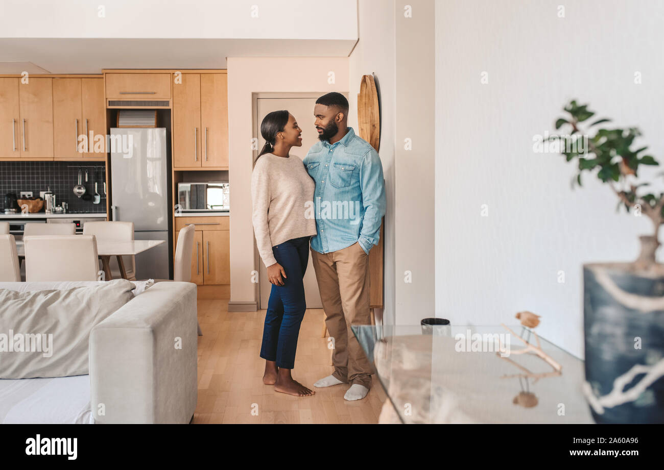 Affectionate young African American couple standing together at home Stock Photo