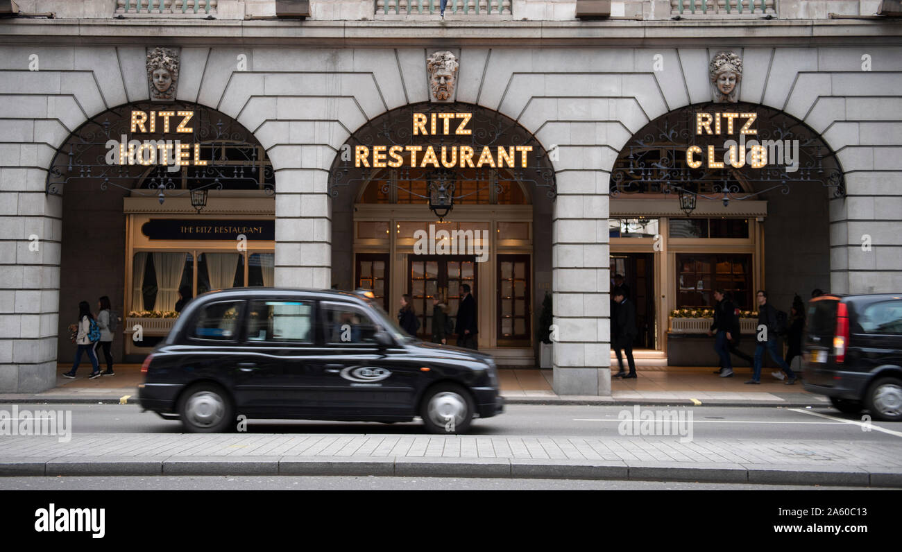 October 2019. Black cab taxi passing The Ritz hotel in Piccadilly, London, UK during morning rush-hour. Stock Photo