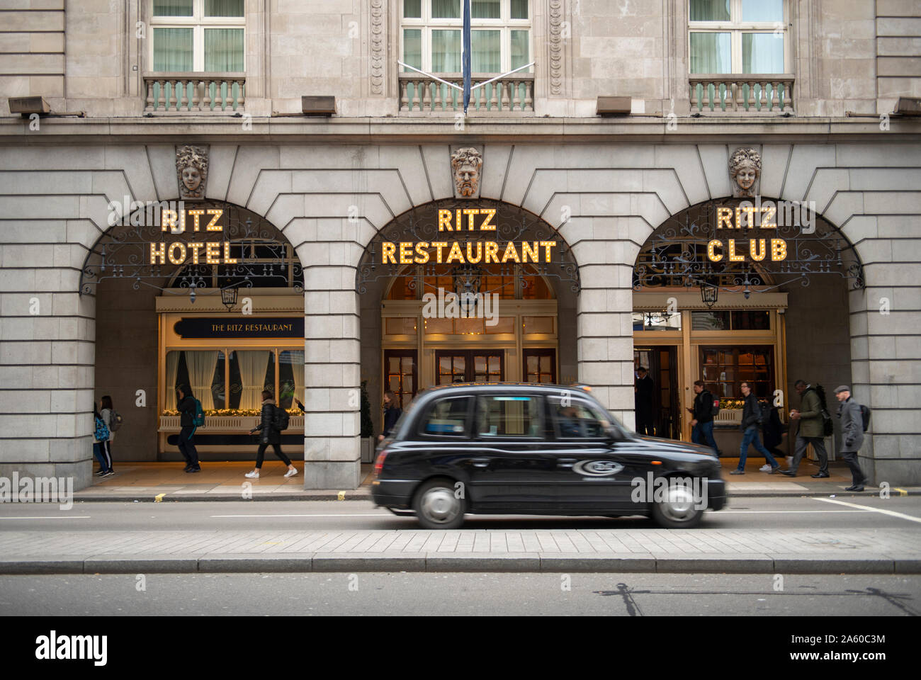 October 2019. Black cab taxi passing The Ritz hotel in Piccadilly, London, UK during morning rush-hour. Stock Photo